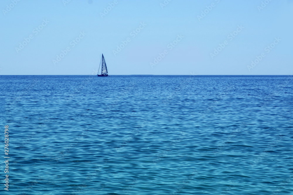 white romantic sailboat sailing on the beautiful blue water of the Mediterranean Sea