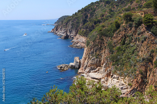 coast blue mediterranean sea with rocks and mountains covered with trees © kittyfly