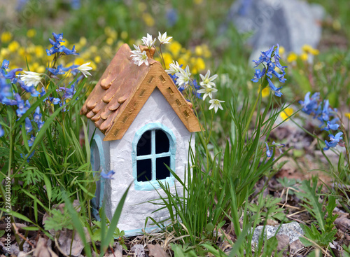 Small white fairy house in grass. © samiramay