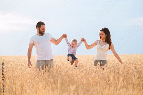 Dreams, happiness, lifestyle, parenthood, love and togetherness. Outdoor portrait of happy family and pet enjoy time together