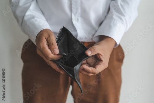 bankruptcy economic financial concept. Person open his empty wallet without money to pay debt in payday.