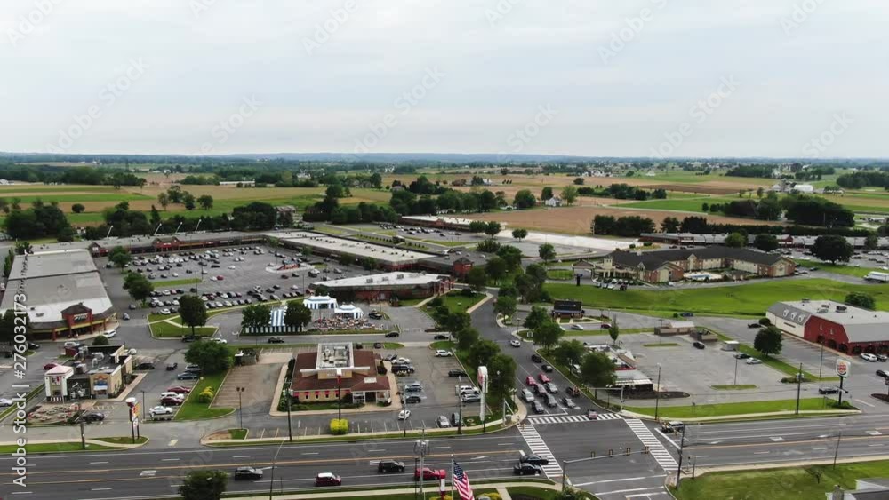 Aerial panning along the Lincoln Highway, US Route 30, tracking traffic as it moves past commercial property, outlet stores, and traffic control, Lancaster, Pennsylvania. Concept: traffic,transport Aerial panning along the Lincoln Highway, US Route 30, tracking traffic as it moves past commercial property, outlet stores, and traffic control, Lancaster, Pennsylvania. Concept: traffic,transport