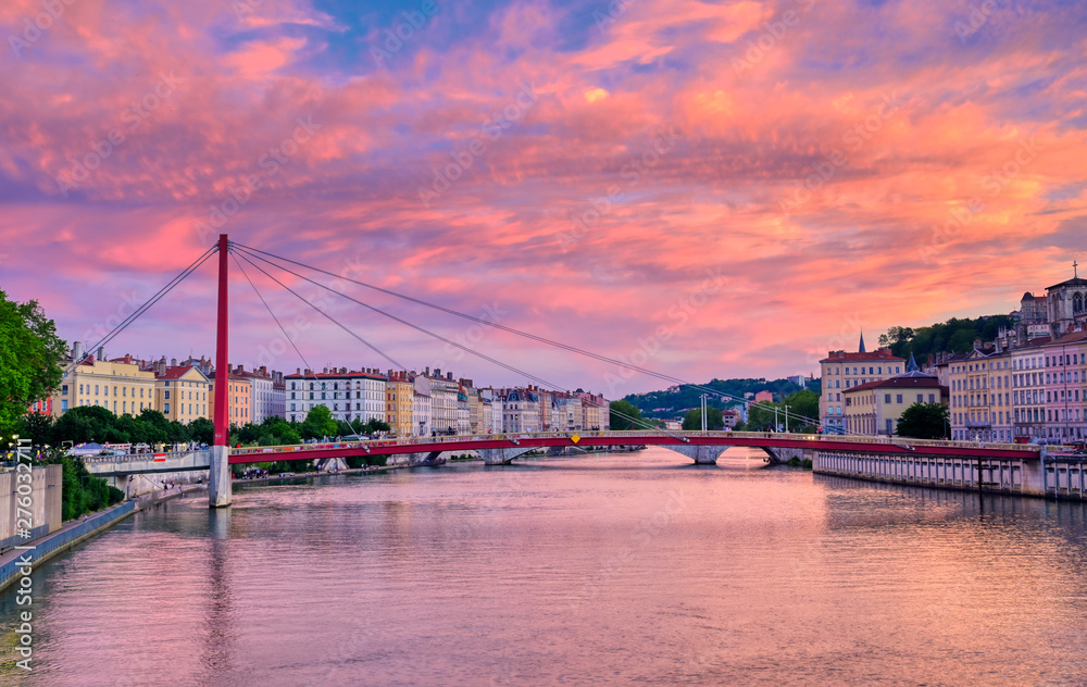 Fototapeta premium A view of Lyon, France along the Saône river at sunset.