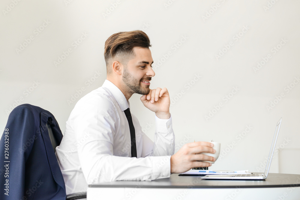 Handsome businessman having break during work in office Handsome businessman having break during work in office