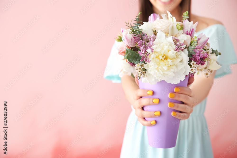 Beautiful young woman with bouquet of flowers on color background Beautiful young woman with bouquet of flowers on color background
