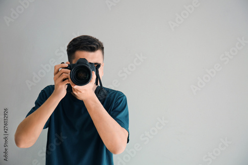 Male photographer on light background photo