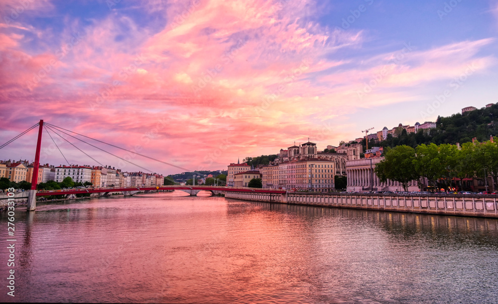 A view of Lyon, France along the Saône river at sunset.