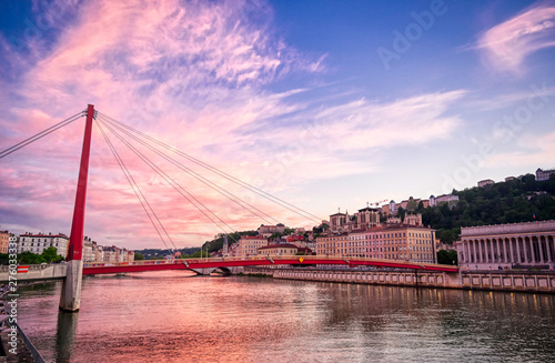 A view of Lyon, France along the Saône river at sunset.