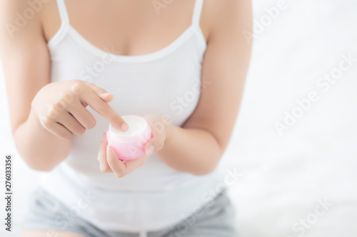 Wallpaper Mural Beautiful with closeup hand asian woman applying moisturizer or lotion skin care cream cosmetic product, girl with treatment moisturizing body care, health and wellness concept. Torontodigital.ca