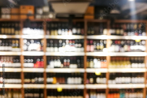 Fényképezés Background blur of wine shelf rack at retail store