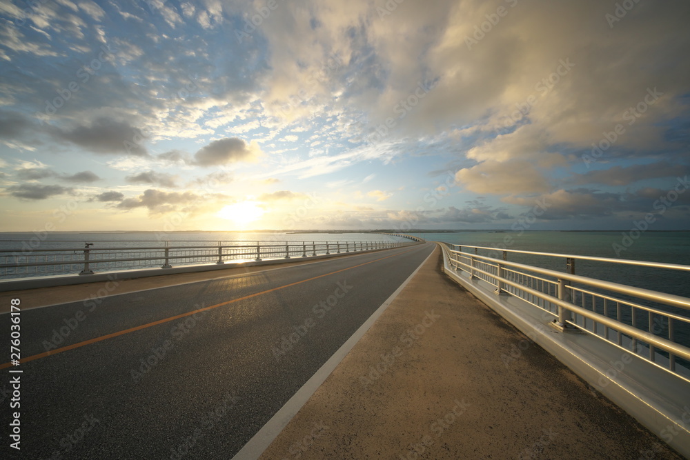 Miyako island, Japan - June 28, 2019: Irabu bridge, the longest charge-free bridge in Japan, connecting Miyako island and Irabu island just after the sunrise Miyako island, Japan - June 28, 2019: Irabu bridge, the longest charge-free bridge in Japan, connecting Miyako island and Irabu island just after the sunrise