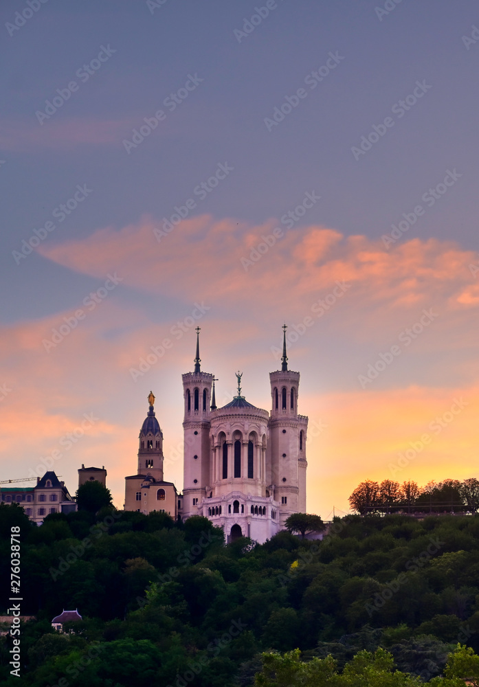 Lyon, France and the Basilica of Notre-Dame de Fourvière at sunset.