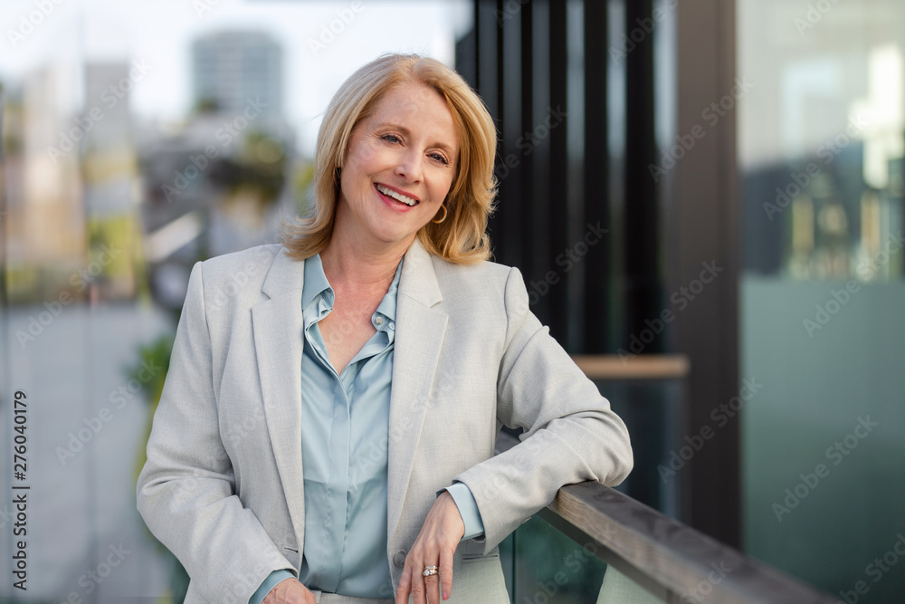 © elnariz - Friendly sincere portrait headshot of a corporate executive business woman in suit, warm friendly and cheerful
