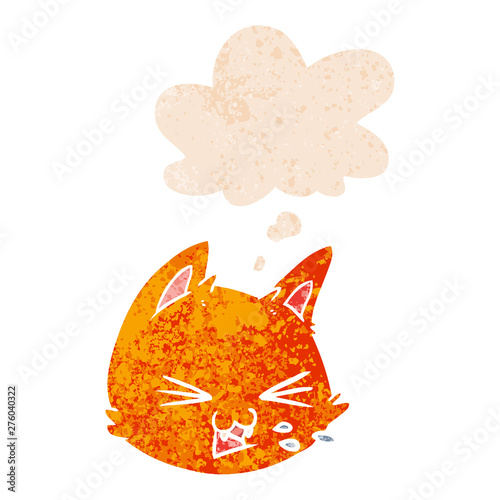 spitting cartoon cat face and thought bubble in retro textured style