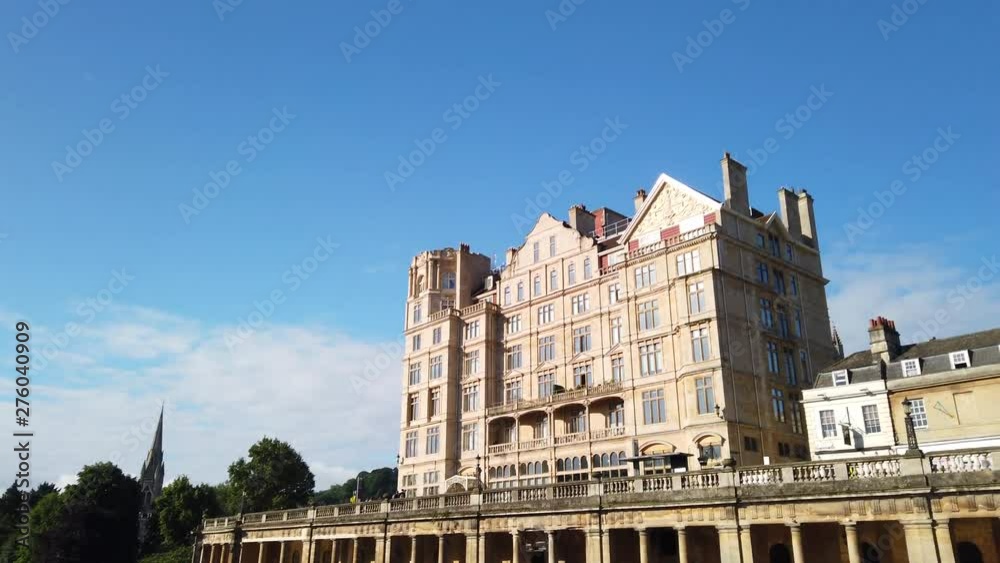 Pulteney Weir and the Empire Hotel in Bath, Somerset on a Beautiful Summer’s Morning fading out diagonally to Clear Blue Sky with Seagull Flying Across Frame