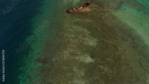 Epic 360 aerial earth shot of a shipwreck on a reef in the Caribbean sea photo