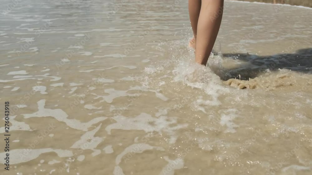 Woman legs on sandy beach. Girl walking on sand by the sea. Beach travel. Summer vacations concepts. Woman legs on sandy beach. Girl walking on sand by the sea. Beach travel. Summer vacations concepts.