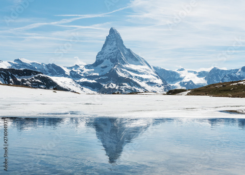 Fototapeta Naklejka Na Ścianę i Meble -  Matterhorn mountain with reflection on melting frozen lake in Zermatt, Switzerland