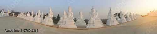 white buddha statue row with sunlight