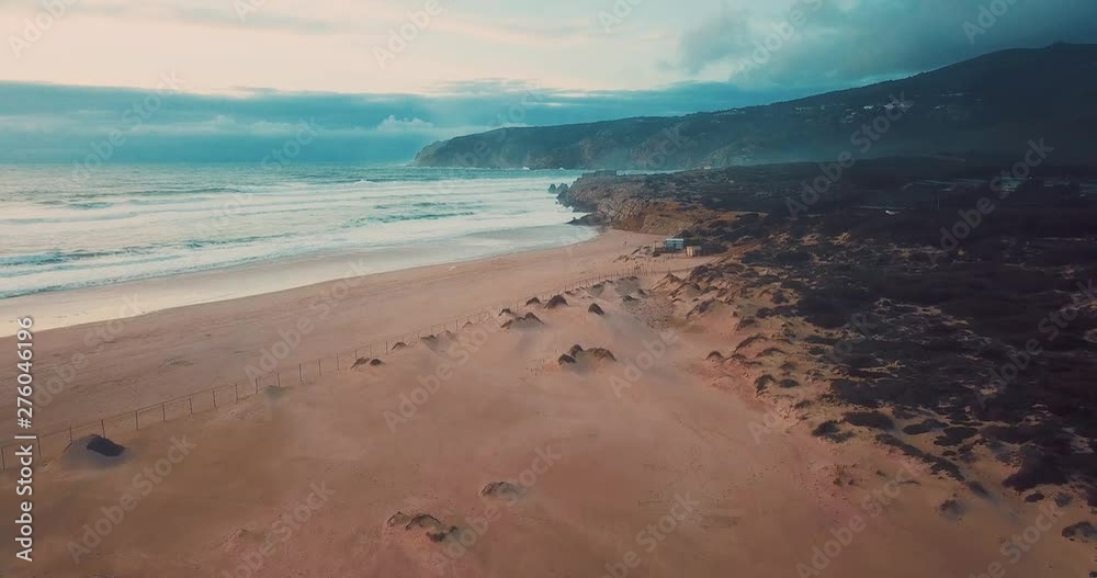 Stormy weather in Guincho beach, Portugal. Aerial view of waves and sand. Stormy weather in Guincho beach, Portugal. Aerial view of waves and sand.