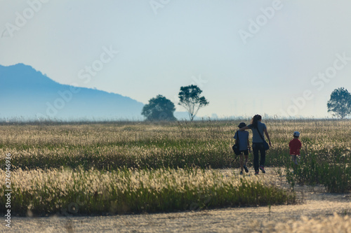 family members running in the fields together © kisstock