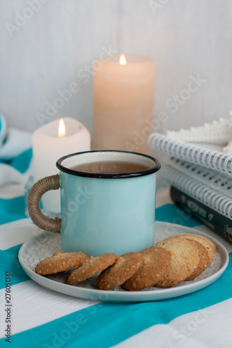 A study break: a mug of tea with cookies on a side.