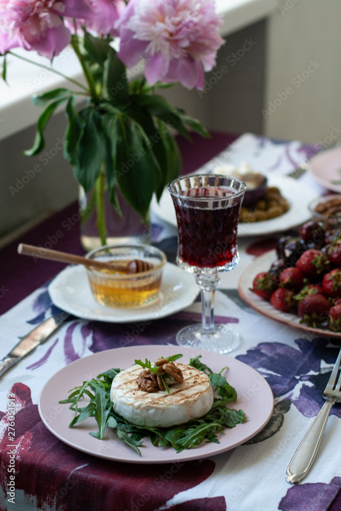 A gourmet dinner for two: grilled camembert, red wine and various appetizers. A gourmet dinner for two: grilled camembert, red wine and various appetizers.