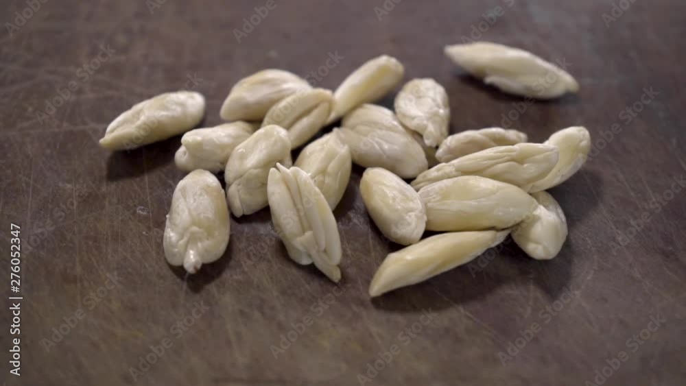A closeup pan of Galip nuts on a wooden table