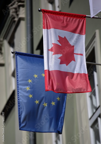 flag of european union and canada hung together outdoor on wall of building