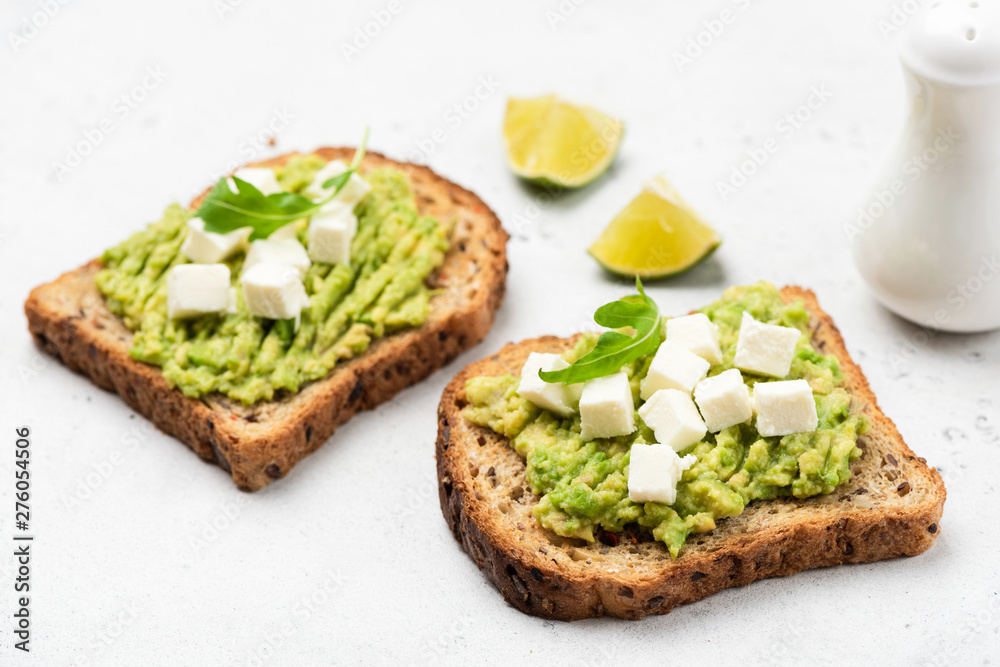 Bread toast with mashed avocado and feta cheese. Healthy breakfast or snack Bread toast with mashed avocado and feta cheese. Healthy breakfast or snack