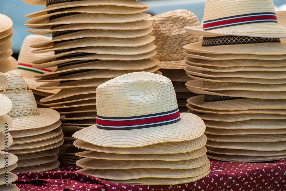 Straw hats in rows at a county fair in Transylvania, Romania.