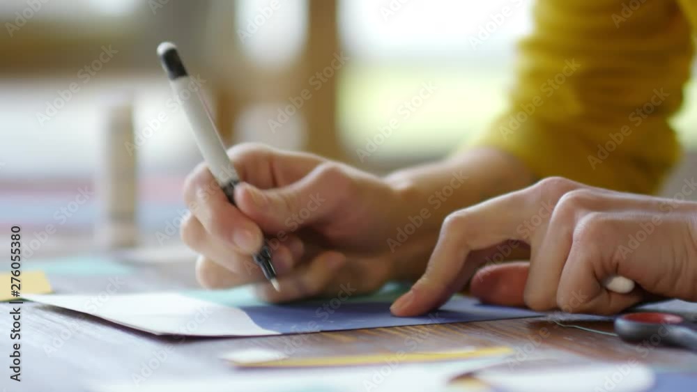Sequence of videos of young female decorator or designer sitting at desk and posting information about available artworks online Sequence of videos of young female decorator or designer sitting at desk and posting information about available artworks online
