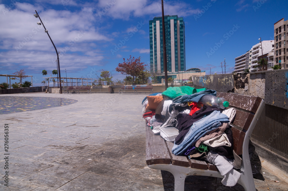 clothes and things left on the bench by the homeless in the city center