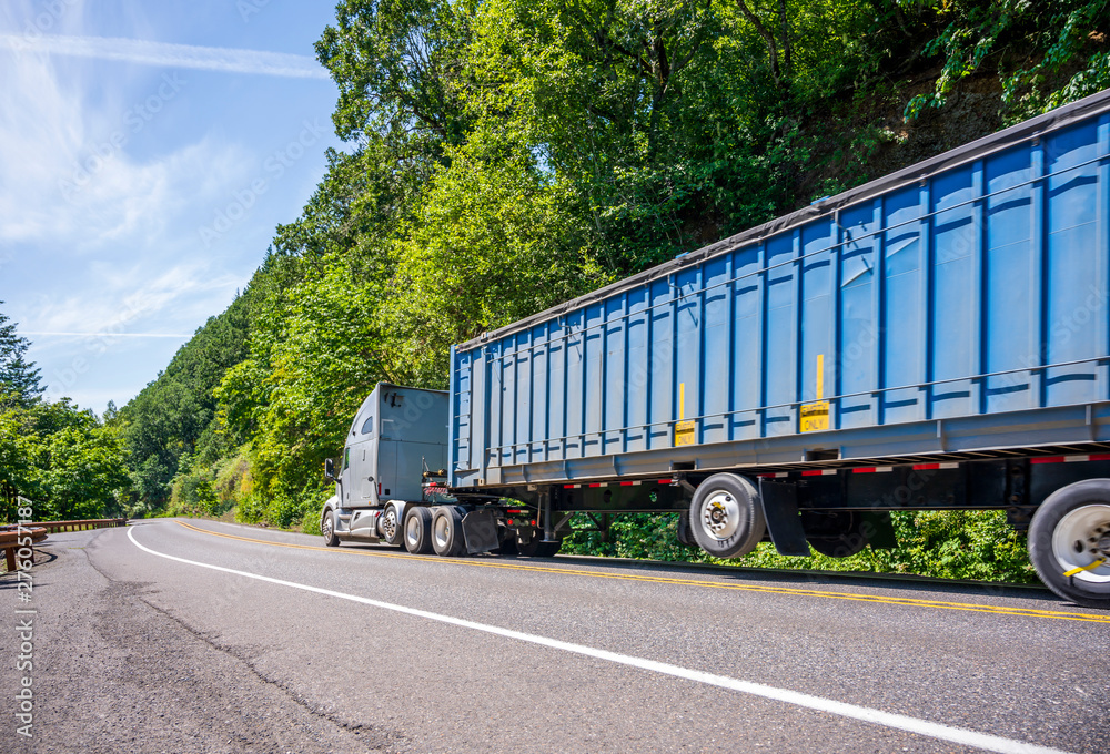 Big rig industrial semi truck with long bulk covered semi trailer ...
