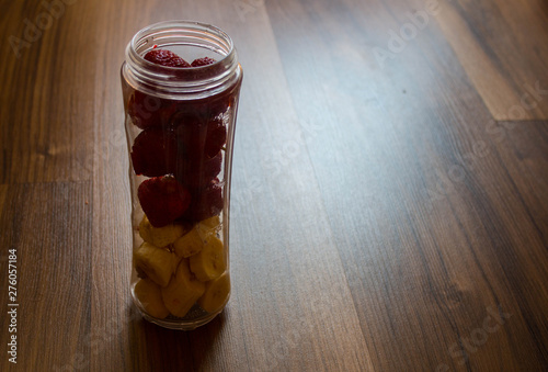 a ingredients for banana and strawberry smoothies in a jar