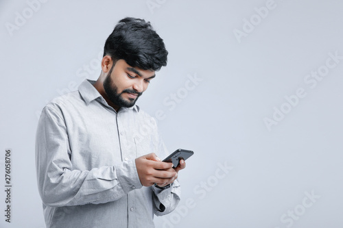 Young indian / Asian man using mobile 