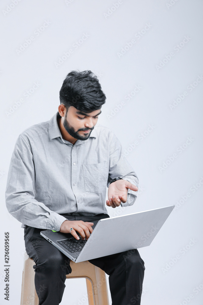 Young Indian / Asian man showing laptop screen Young Indian / Asian man showing laptop screen