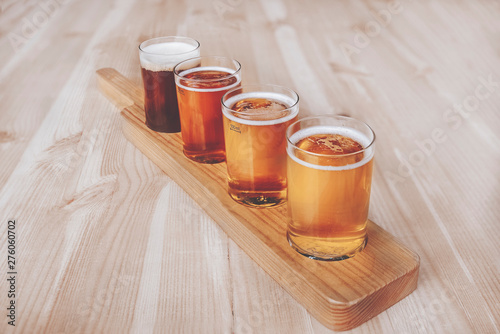 Beer tasting. Diferent beer in 100 mililiter glases over wooden table. Cross-processed. Vintage style. Instagram filter.