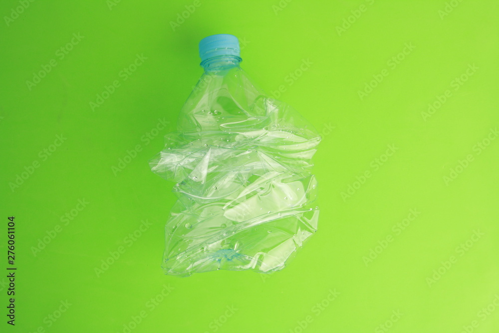 Empty plastic water bottle scaled for recycling