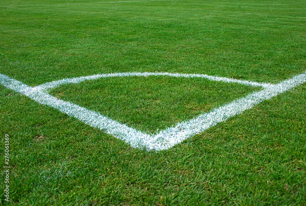 White corner lines on empty soccer grass field