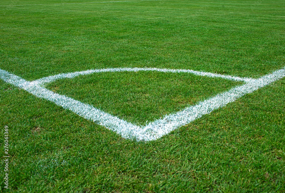 White corner lines on empty soccer grass field White corner lines on empty soccer grass field