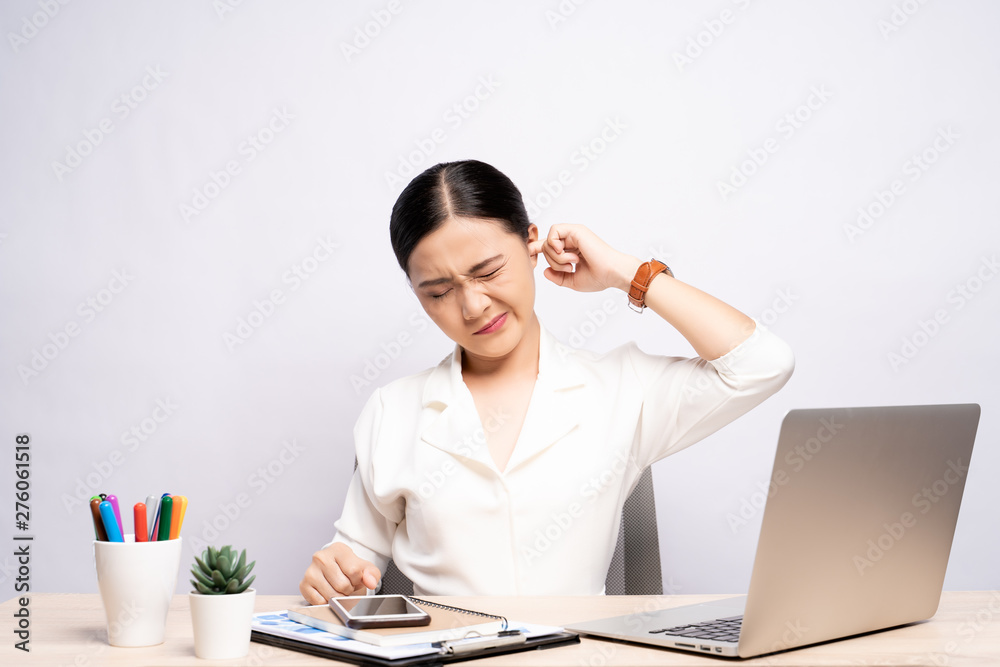 Woman putting a finger into her ear at office isolated white background Woman putting a finger into her ear at office isolated white background