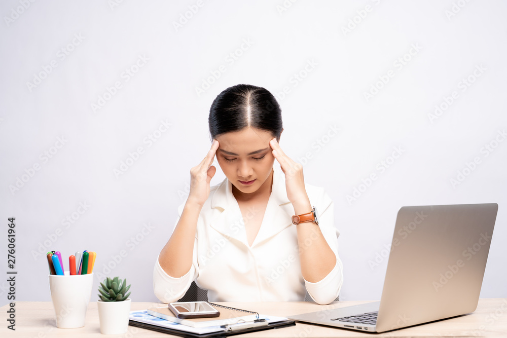 Woman has headache at office isolated over white background Woman has headache at office isolated over white background