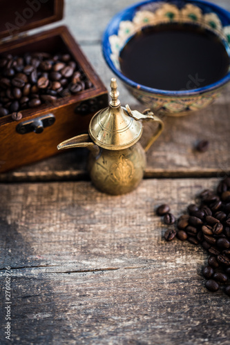 Coffee cup and coffee beans on wooden background. Top view