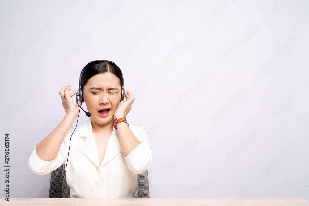 Woman operator in headset feel annoyed over white background Woman operator in headset feel annoyed over white background