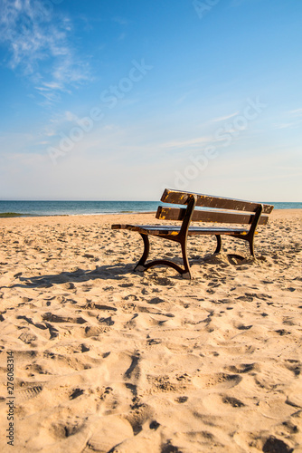 Fototapeta Naklejka Na Ścianę i Meble -  bench on a lonesome beach of the Baltic Sea with blue sky