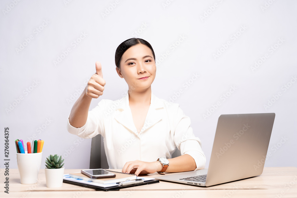 Happy woman showing thumb up at office isolated over background Happy woman showing thumb up at office isolated over background