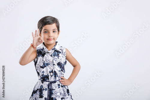 Indian little girl showing direction with hand