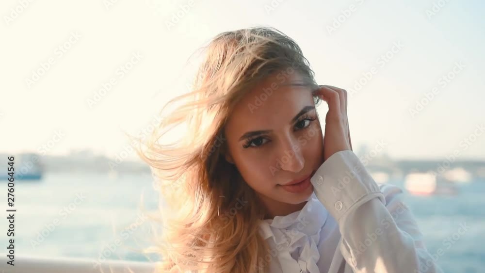 Beautiful girl enjoys moment while cruising with view of sea on background.Traveler concept Beautiful girl enjoys moment while cruising with view of sea on background.Traveler concept