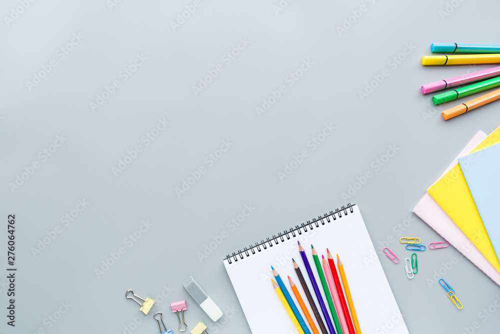 School supplies stationery, colour pencils, clips, paper on gray background,  back to school concept with copy space for text, overhead, modern  elementary education. flat lay, top view, mockup Stock Photo | Adobe
